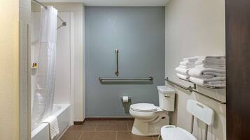 A bathroom with a bathtub, toilet, and a shower curtain.