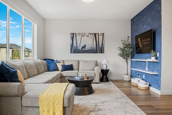 Main floor living room with a smart TV, cozy seating & access to the private patio space.