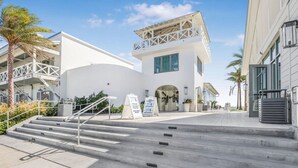 A modern building with a white facade, a balcony, and a staircase leading to the entrance. - Cotton Bayou 2H 3BR With Loft (Orange Beach)