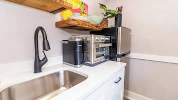 Oven, coffee/tea maker, cookware/dishes/utensils, dining tables