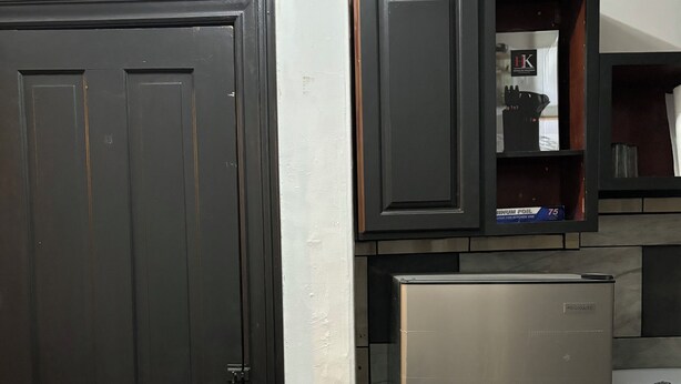 A kitchen with a black door, a refrigerator, and a stove. - Temple Hosp 2nd floor (Philadelphia)