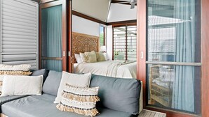 A room with a sofa, a bed, and a large window with curtains. - Luxury On The Bay 2 - Ocean Views (Byron Bay)