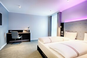 Relax in a spacious room with a large bed, desk, and flat-screen TV.