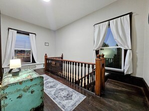 A staircase with wooden railings, a patterned rug, and a vintage suitcase. - Brickhaven: Bristol`s Landmark 1880s Brick Home (Bristol)