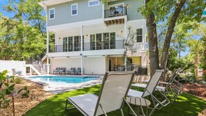 A two-story house with a pool, outdoor seating, and a balcony. - 221 Cordillo at S Forest Beach, New Build, Easy to Beach, Private Pool (Hilton Head Island)