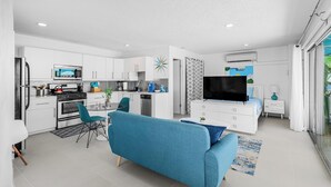 A modern apartment with a kitchen, dining area, and living room. - South Palm Springs Studio - Unit 101 Float Apartments (Palm Springs)