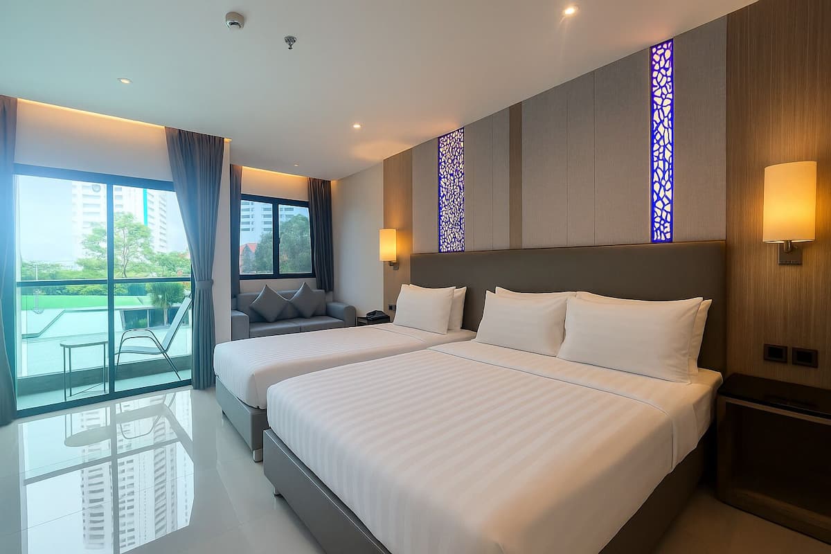 A modern hotel room with two beds, a balcony, and a view of the city.
