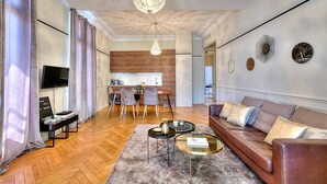 A modern living room with a sofa, coffee table, and TV.