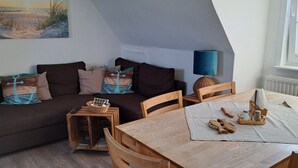 Une pièce chaleureuse avec un canapé, une table en bois et une lampe.
