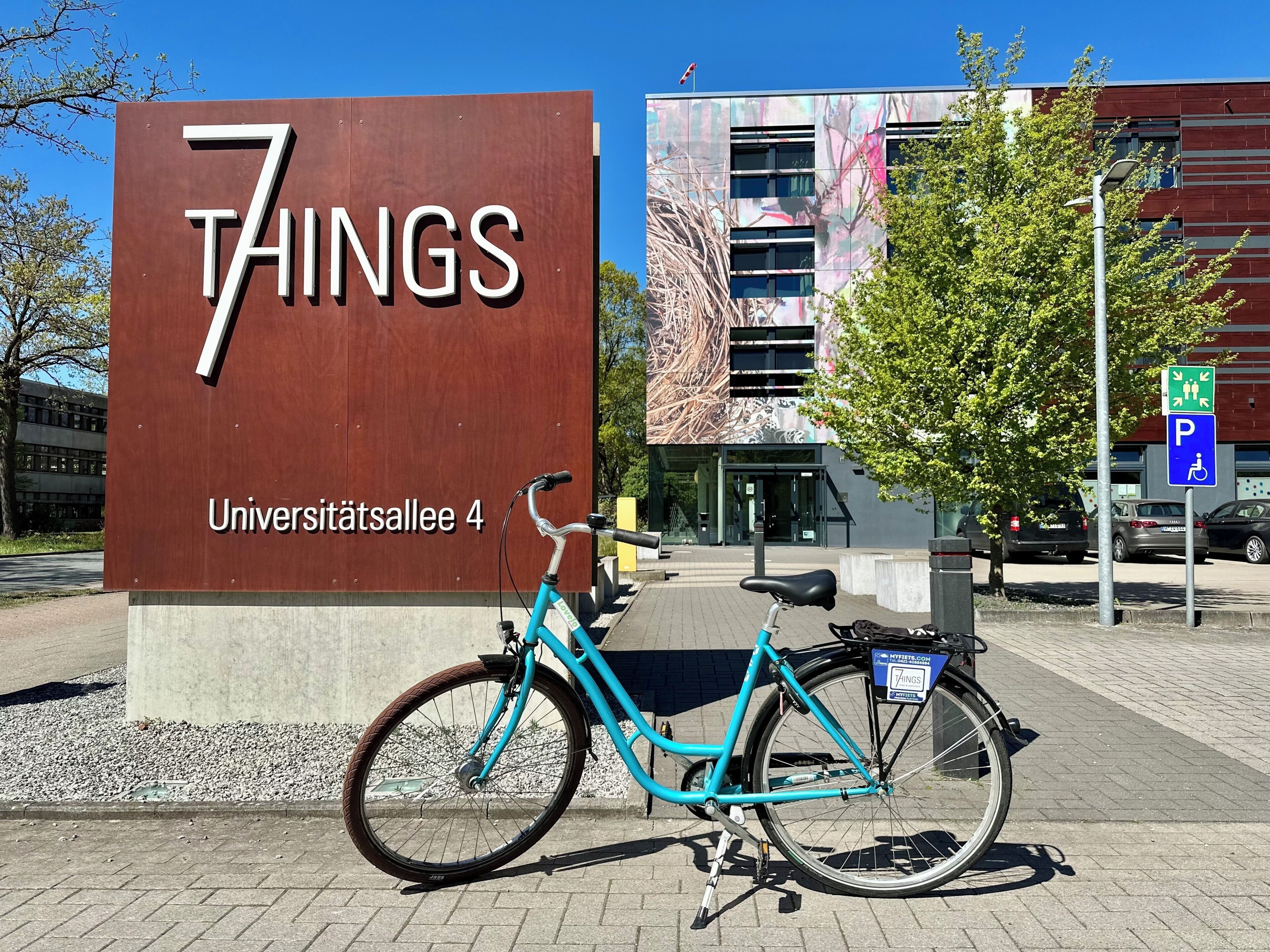 A sign for '7 THINGS' with a bicycle parked in front.