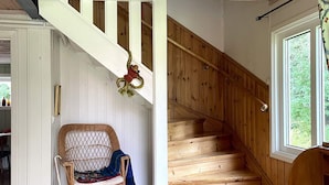 A wooden staircase with a view of greenery outside. - 4 Star Holiday Home in Torso (Torsö)