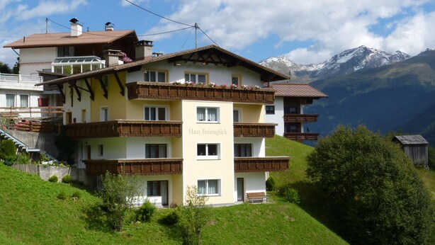 A multi-story hotel with balconies, a sign reading "Haus Ferienblick," and a mountainous backdrop. - Holiday Apartment in Kappl Near ski Resort (Kappl)