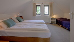 A bedroom with two beds, a window, and a radiator. - Bungalow in Sondel Near Slotermeer Lake (Sondel)