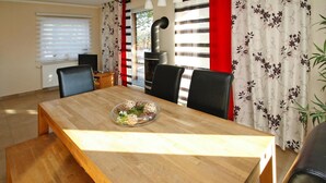 A dining area with a wooden table, black chairs, and a decorative bowl on the table.