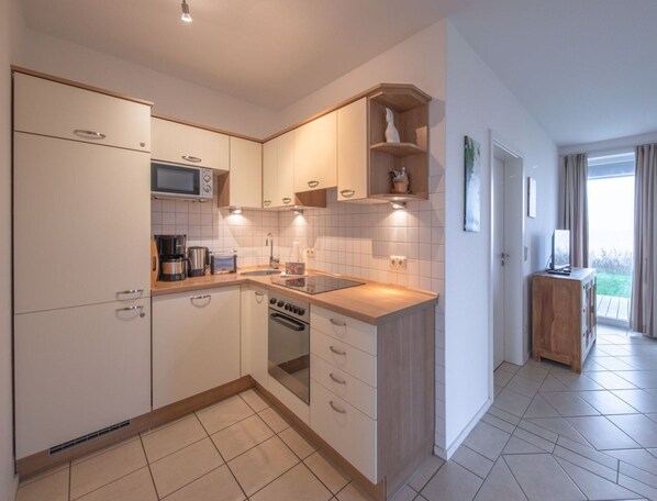 Appartement | Cuisine privée | Bouilloire électrique, grille-pain, chaise haute