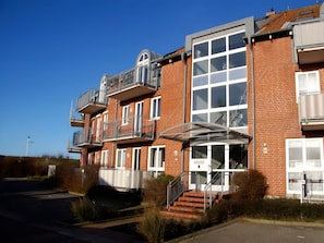 A multi-story residential building with balconies and a covered entrance. - 4 Star Holiday Home in Neuschonberg (Schönberg)
