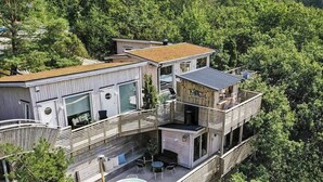 A modern multi-story house with a rooftop pool, large windows, and a balcony with outdoor seating. - 4 Star Holiday Home in Hisings Backa (Hisings Backa)