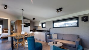 A modern living space with a kitchen, dining area, and seating area. - Waterfront Stay w/ Pets (Delfstrahuizen)