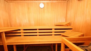 A sauna with wooden benches and a tiled floor.