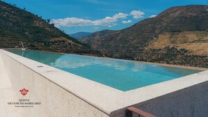 A pool with a clear view of a hilly landscape in the background.