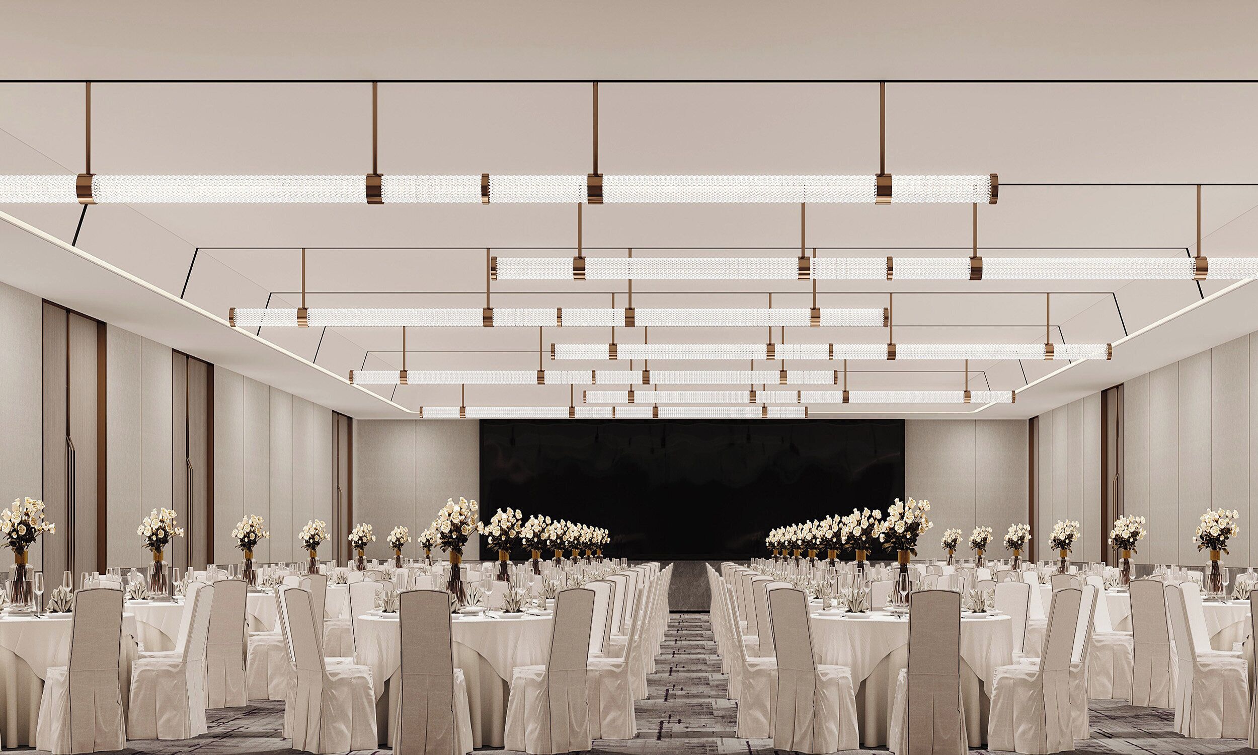 A banquet hall with rows of tables and chairs, a stage at the front, and a modern ceiling design.