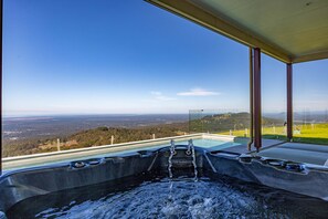 A hot tub with a panoramic view of a landscape, including hills and a clear sky. - Petrichor Estate - 360 Views, Magnesium Pool & Spa (Sunshine Coast Hinterland)