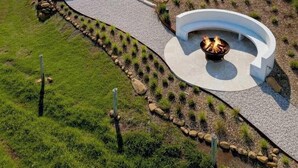 A modern house with a swimming pool, outdoor seating, and a fire pit. - Petrichor Estate - 360 Views, Magnesium Pool & Spa (Sunshine Coast Hinterland)