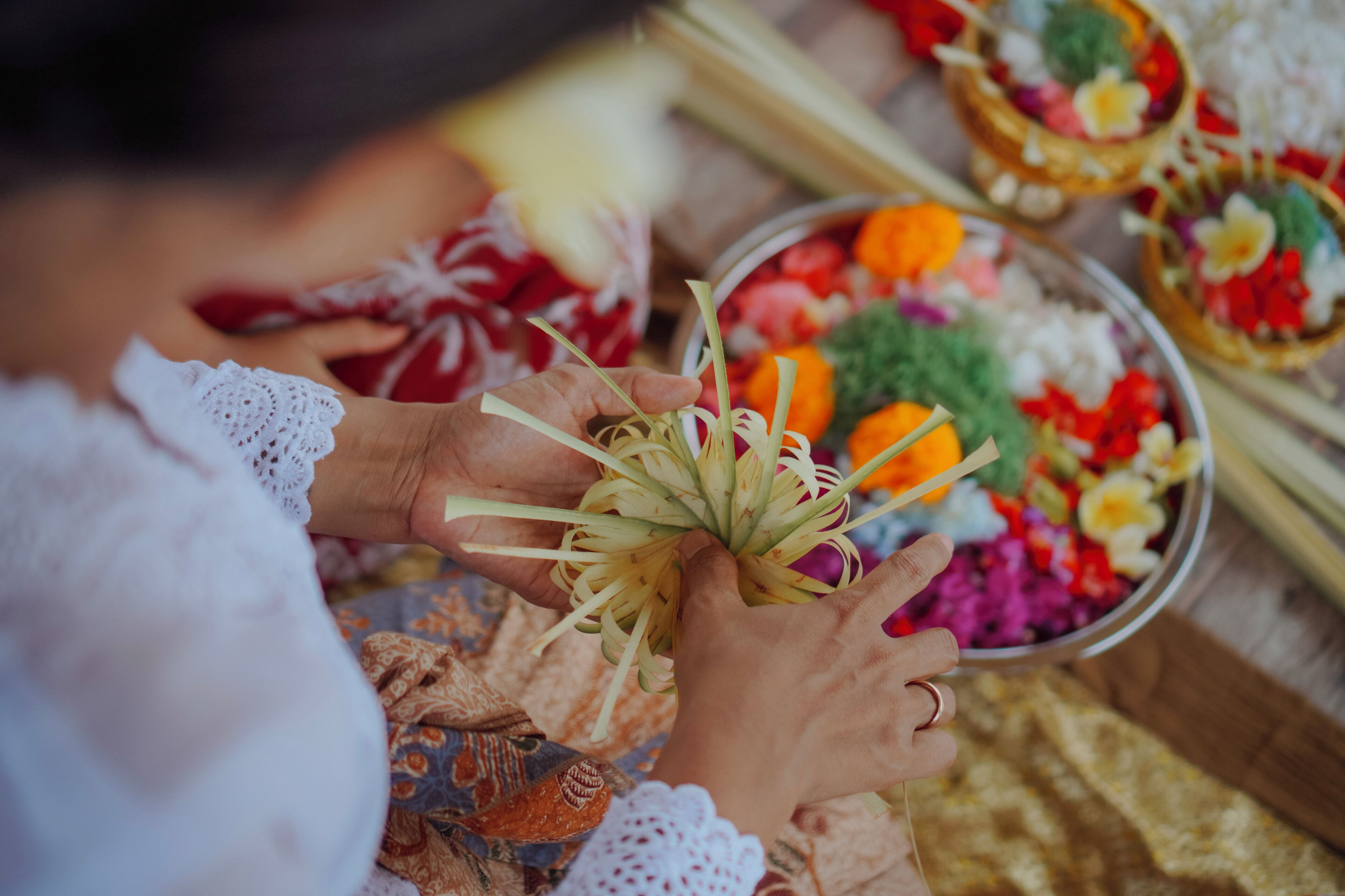 A person holding a bowl with colorful food items.