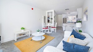 Un apartamento moderno con sala de estar, comedor y cocina.