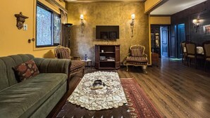 A cozy living room with a fireplace, a sofa, and a coffee table.