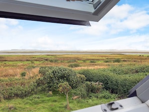 A view from a window overlooking a marshy landscape with a distant horizon. - 5 Person Holiday Home in Veslos (Vesløs)