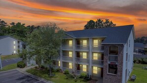 A multi-story hotel with a brick facade and multiple balconies. - CB 3504-103 Fayetteville Oasis I Modern, Comfy (Fayetteville)