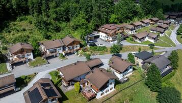 A residential area with multiple houses, each featuring a sloped roof and a front porch.