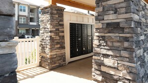 A stone pillar and a mailbox in a residential area.