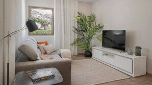 Una sala de estar moderna con un sofá, un televisor sobre un mueble blanco, una planta grande y una ventana con cortinas.