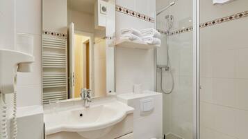 Een moderne badkamer met een wastafel, spiegel en toilet.