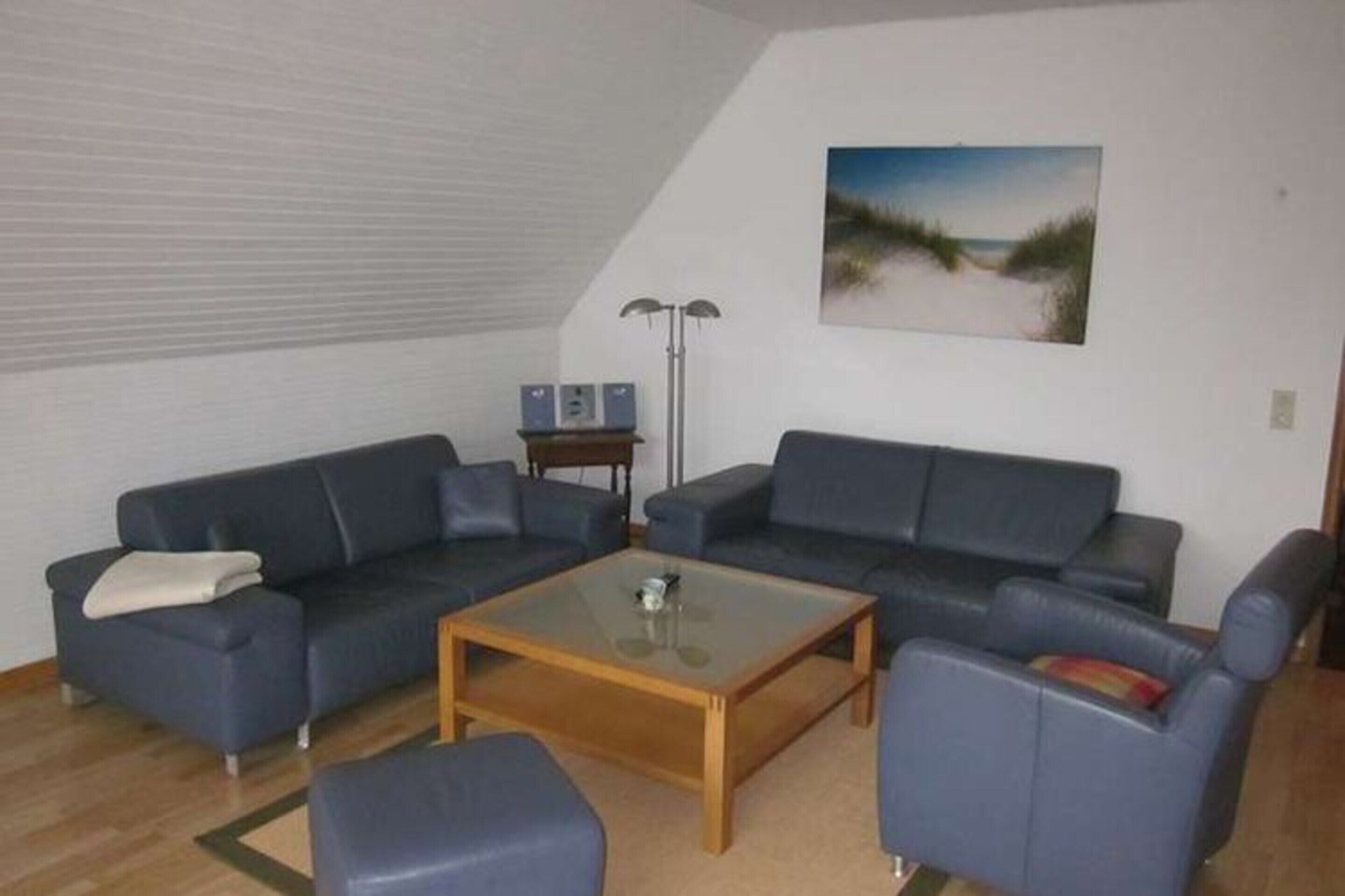 A living room with two sofas, a coffee table, and a lamp.