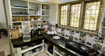 A calm and cosy three-bedroom house in the mountain valleys near Munnar.