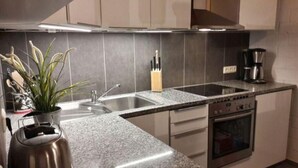 A modern kitchen with granite countertops, stainless steel appliances, and a built-in oven.