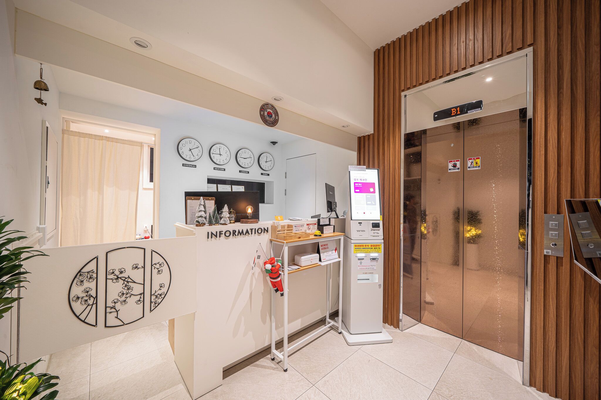 A reception area with a desk labeled "INFORMATION," a clock, and an elevator marked "B1."