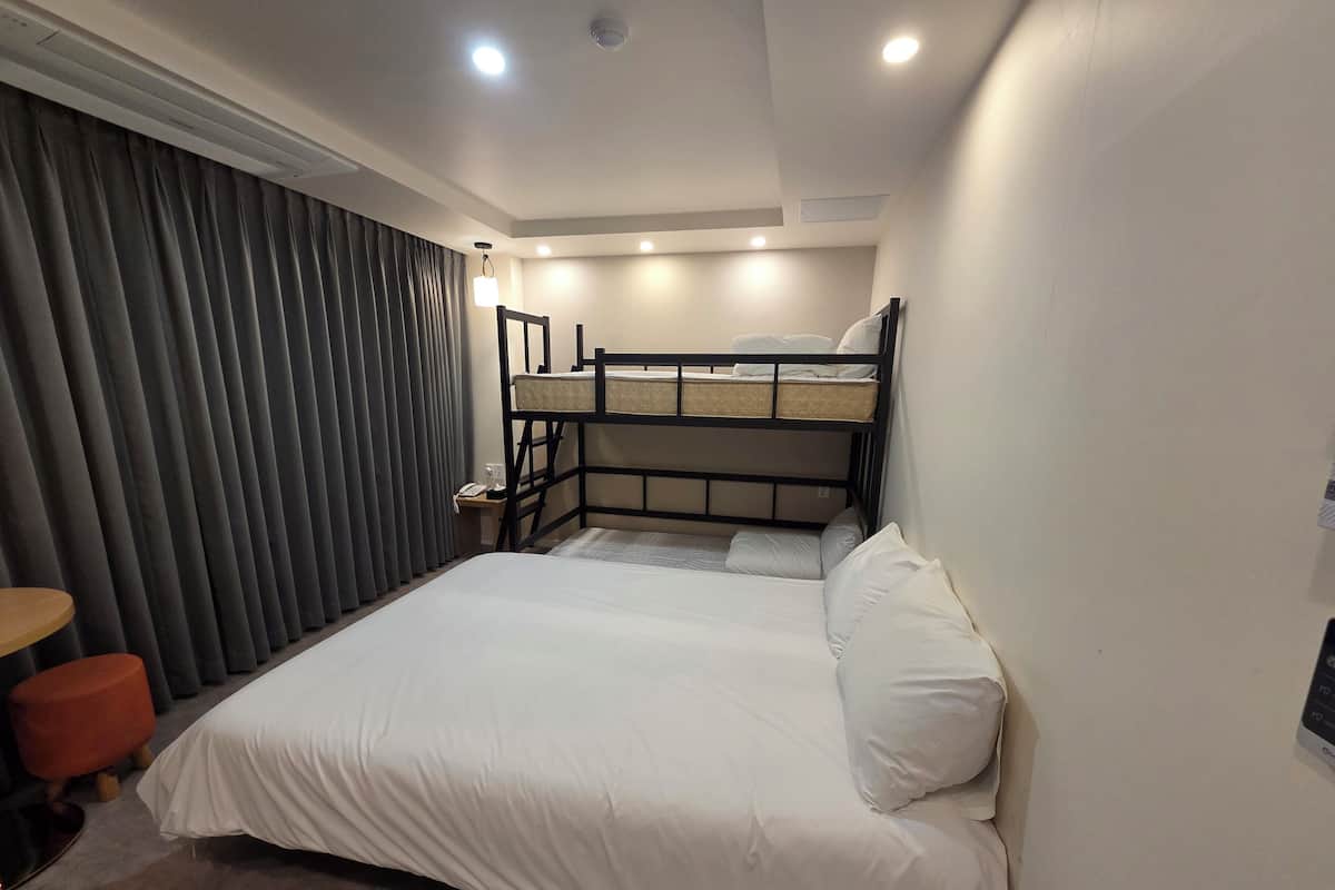 Premium bedding, desk, laptop workspace, blackout drapes