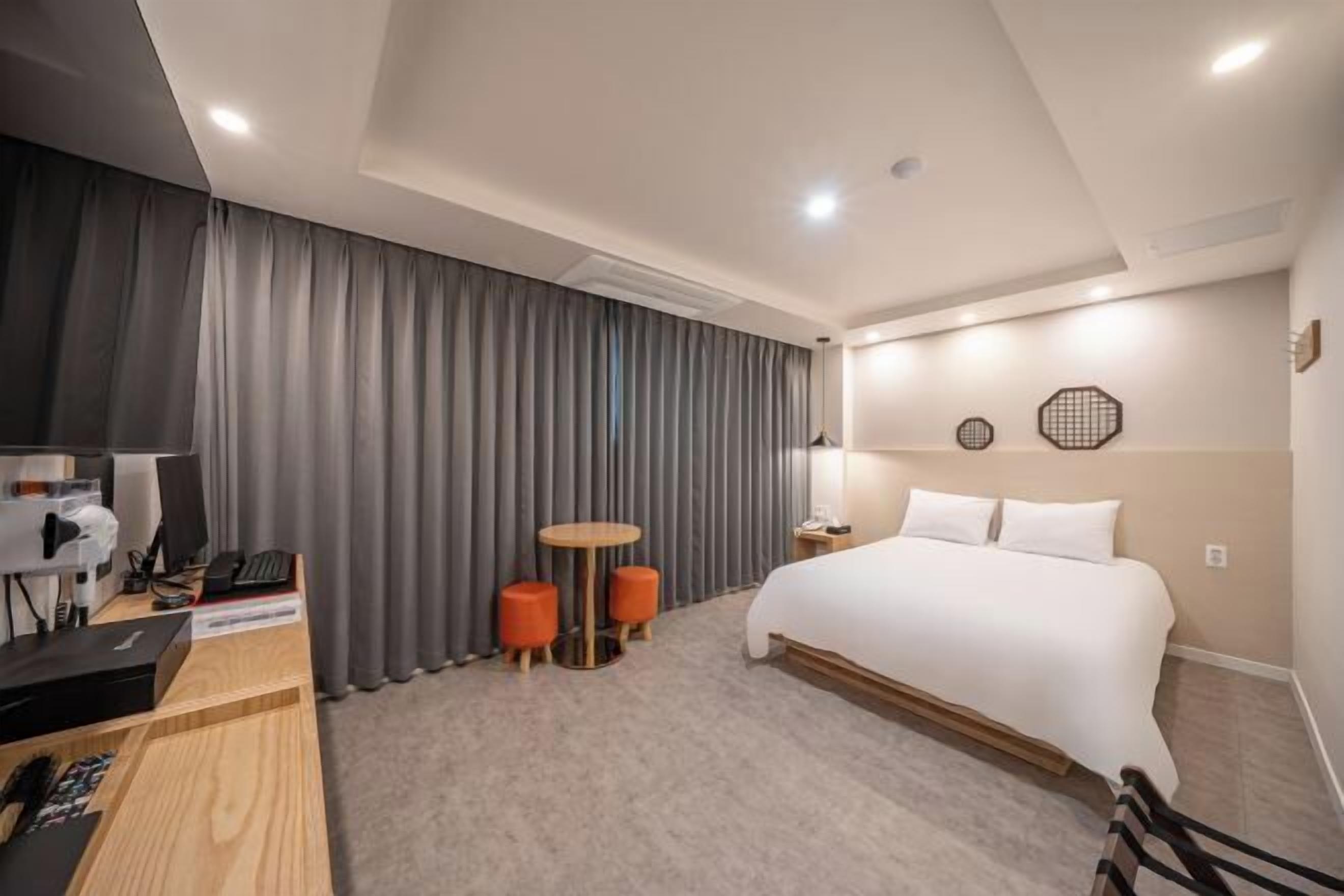 Premium bedding, desk, laptop workspace, blackout curtains