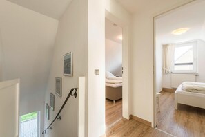 Cozy retreat with a comfortable bed, a small table, and a chair.