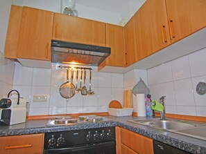 Fully equipped kitchen with dishwasher, stove, and sink.