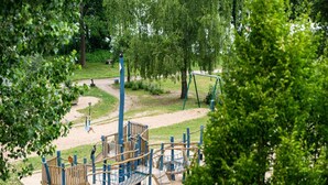 A playground with climbing structures, slides, and a swing set. - Ideale Familienwohnung in der Natur (Mirow)