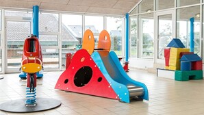 A children's play area with a slide, climbing structures, and a spring-mounted toy. - 6 Person Holiday Home on a Holiday Park in Hemmet (Hemmet)