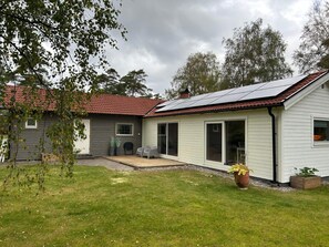 A two-story house with a red-tiled roof, a covered patio, and a solar panel installation. - 4 Star Holiday Home in Mellbystrand (Mellbystrand)