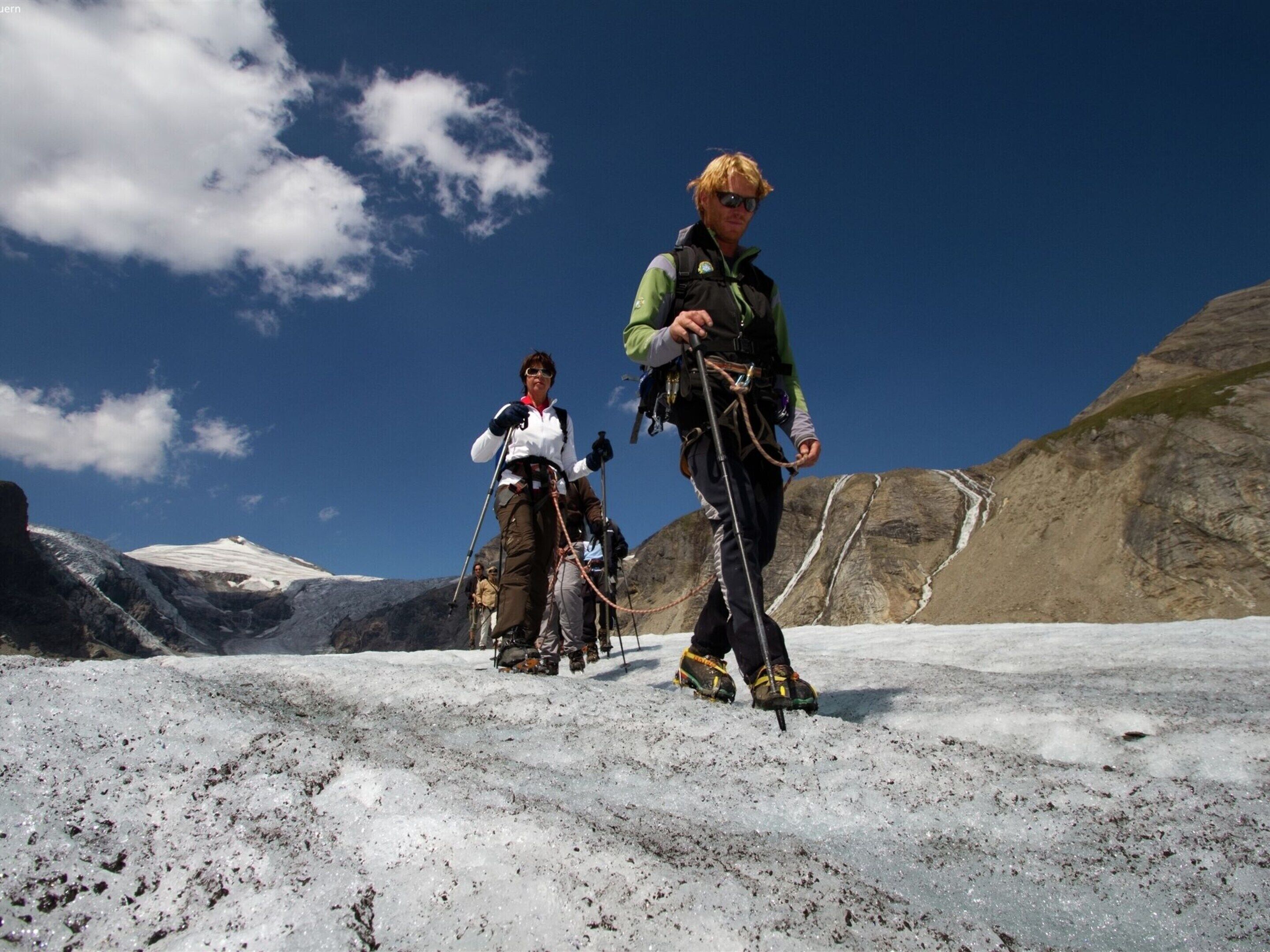 A glacier with two people in mountaineering gear.