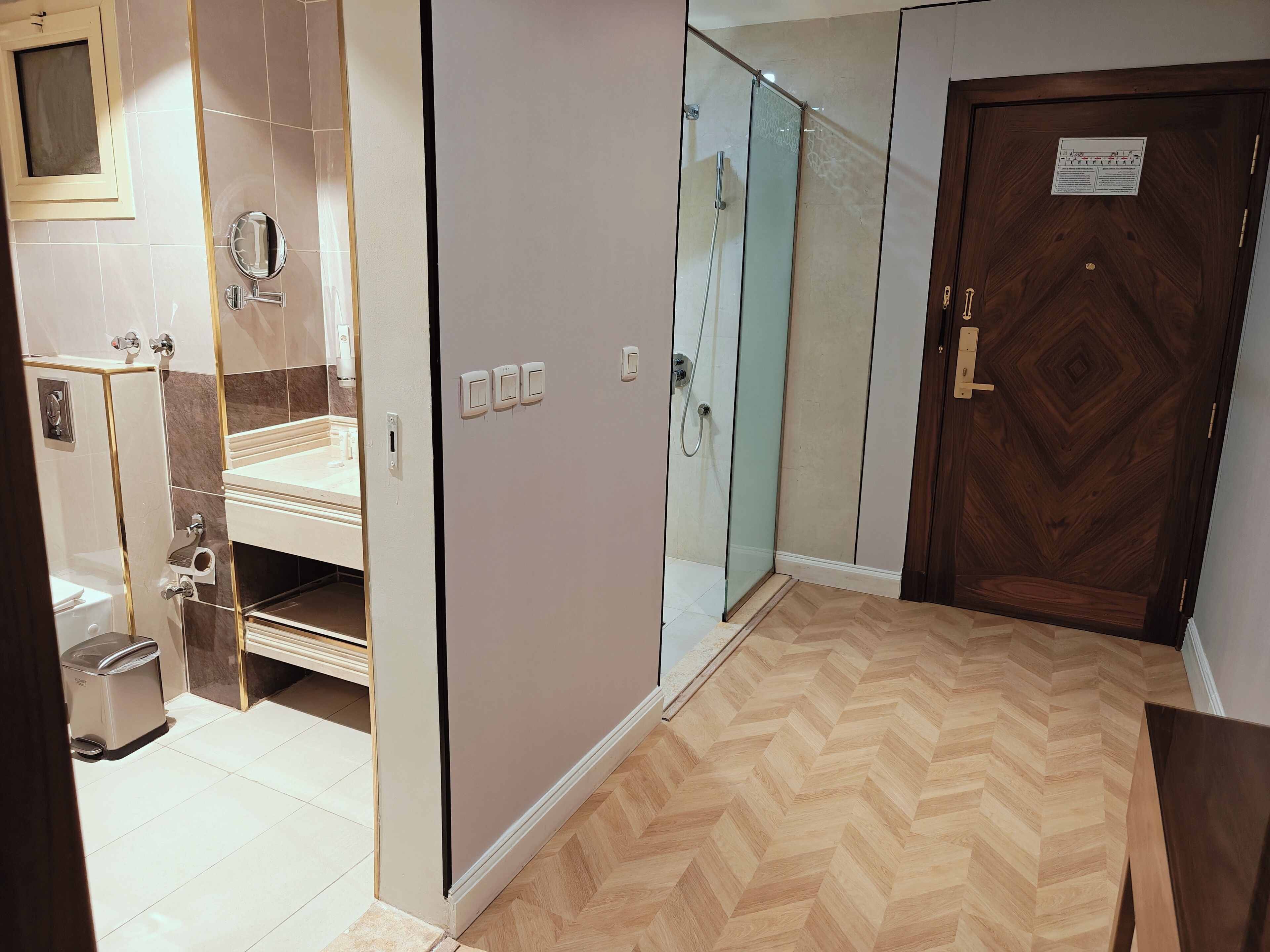 A bathroom with a shower, toilet, and sink.
