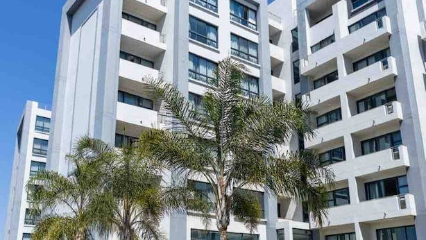 A modern hotel with multiple floors, a swimming pool, and outdoor seating areas. - Stylish & Elegant With Epic Views Near Menlyn (Pretoria)